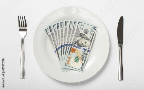 Money on a white plate on a white background