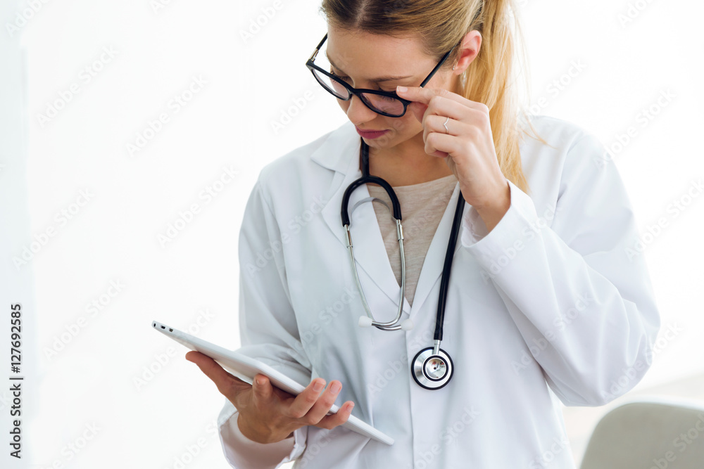 Female doctor using her digital tablet in the office. Female doctor using her digital tablet in the office.