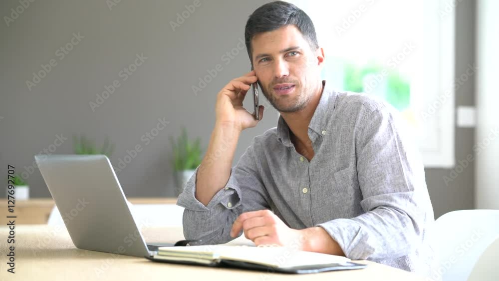 Middle-aged man working from home on laptop computer Middle-aged man working from home on laptop computer