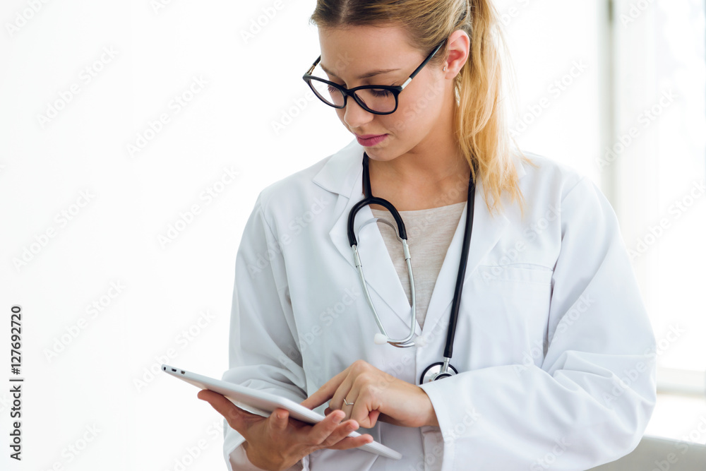 Female doctor using her digital tablet in the office.