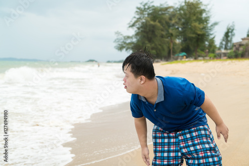Portrait of Down Syndrome boy on the beach