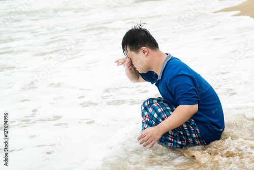 Portrait of Down Syndrome boy on the beach