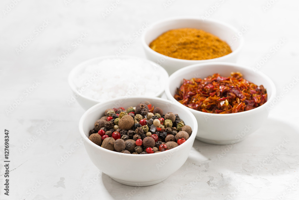 assortment of pepper, salt and spices in bowls assortment of pepper, salt and spices in bowls