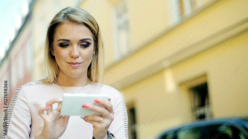 Girl looking absorbed while texting on smartphone in the alley
Girl looking absorbed while texting on smartphone in the alley