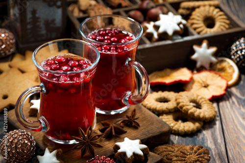 Christmas hot cranberry tea and cookies on dark table