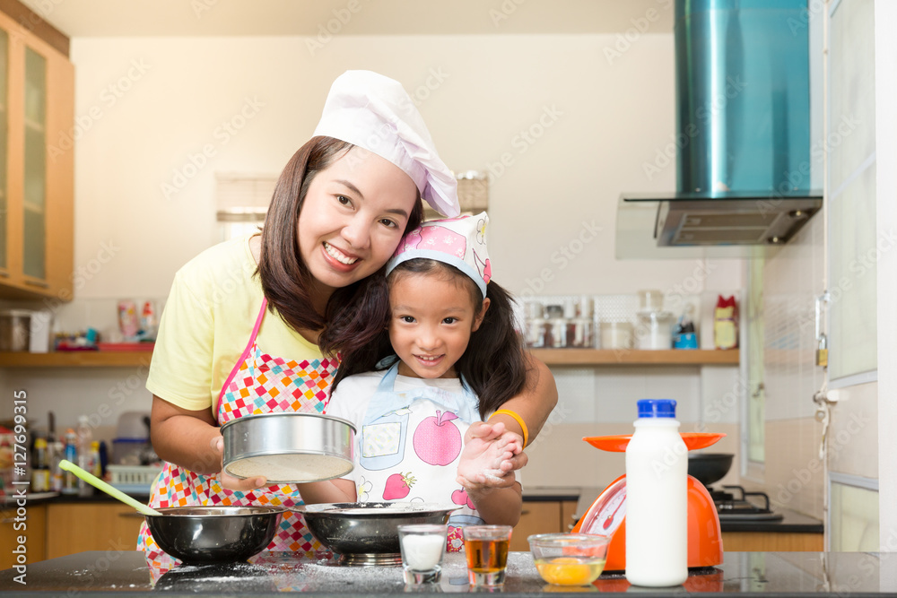 Asian family enjoy making pancake in kitchen Asian family enjoy making pancake in kitchen