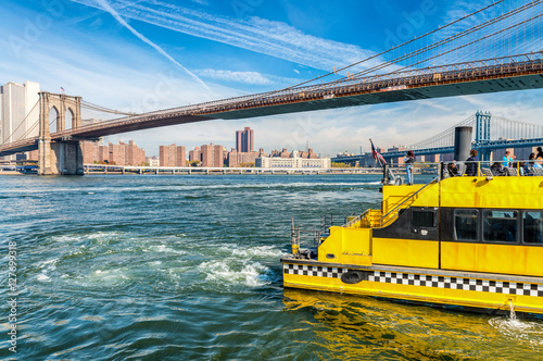 Yellow boat crossing river in New York City