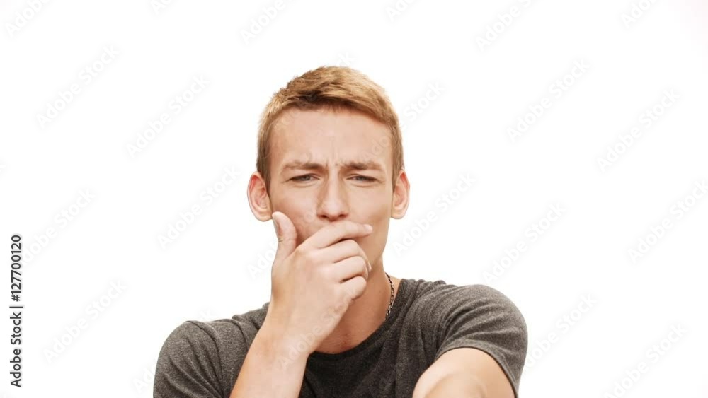 Emotive young handsome man shouting, pointing finger away over white background. Slow motion. Emotive young handsome man shouting, pointing finger away over white background. Slow motion.