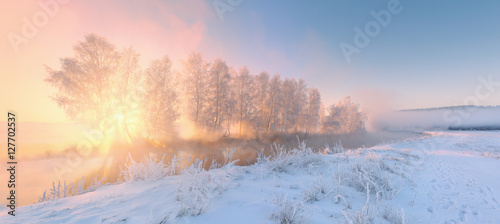 Winter landscape with sun rays