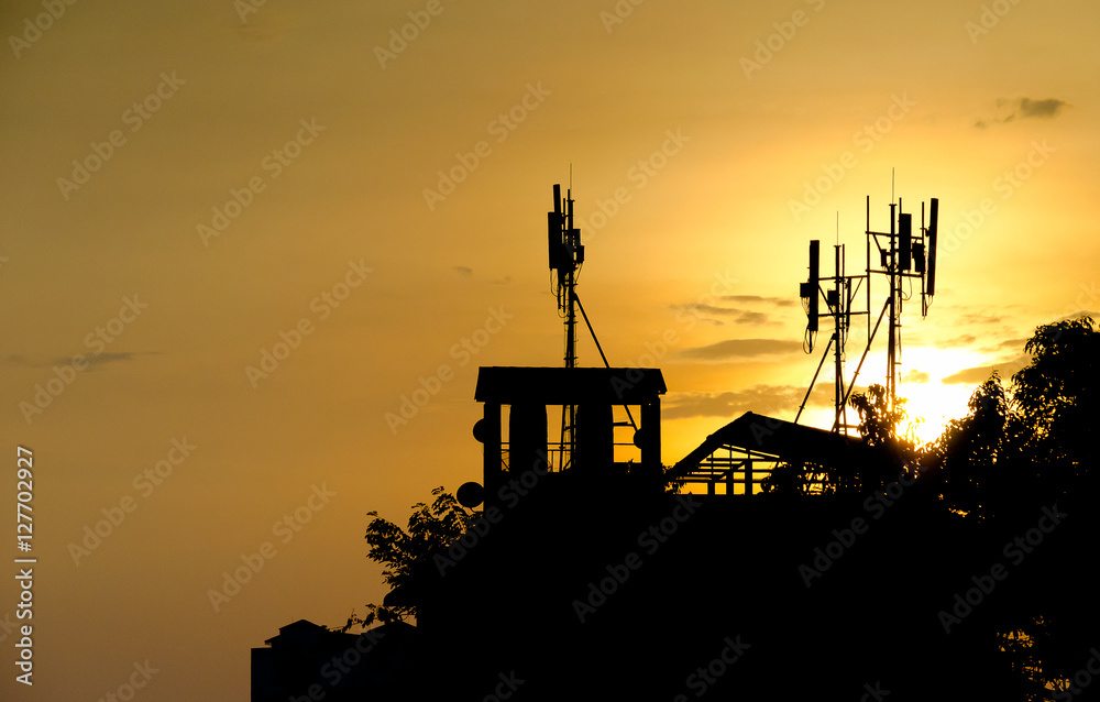 A view of communication pole in the sunset silhouette view