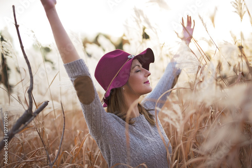 Принти на полотні Woman in a wheat field at sunset