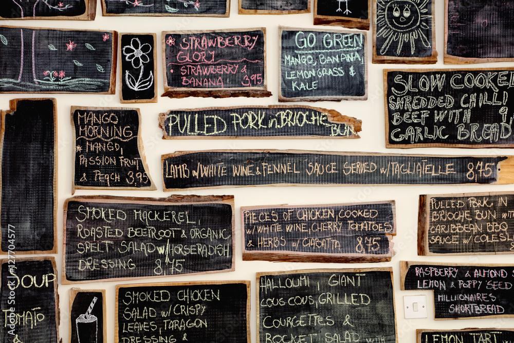 Quirky coffee shop interior with menu on chalked blackboards Stock