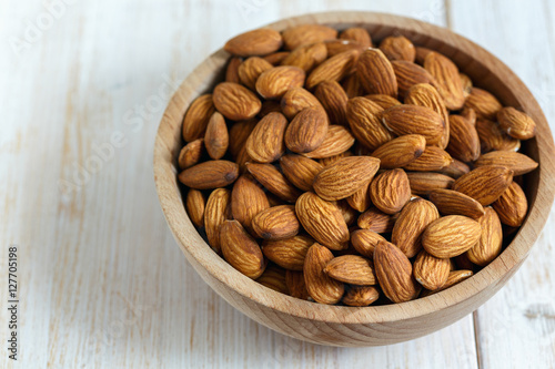 Almonds in bowl closeup.