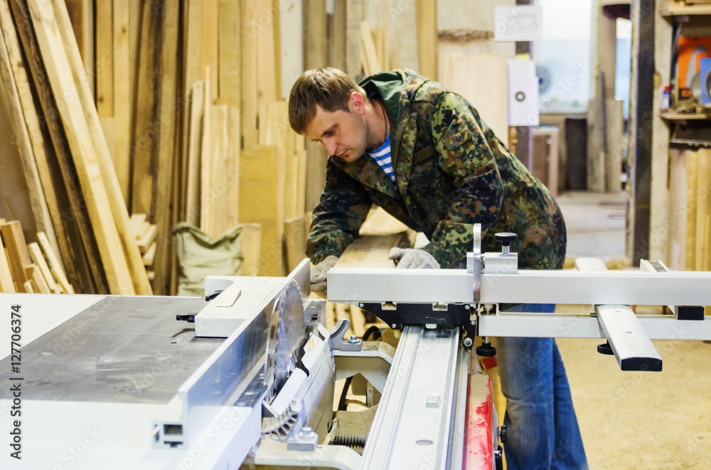 Carpenter at work on woodworking machines with a circular saw Carpenter at work on woodworking machines with a circular saw