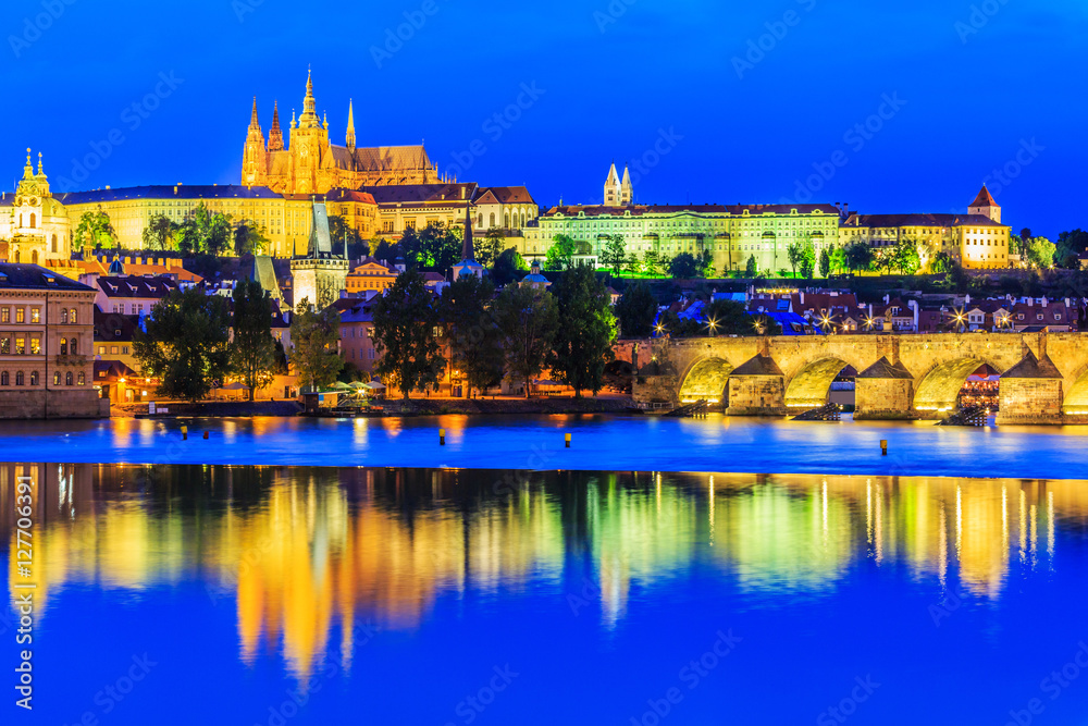 Prague, Czech Republic. Charles Bridge,  Hradcany (Prague Castle) and St. Vitus Cathedral at twilight dusk.
