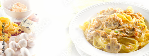 Plate of pasta with mushrooms and cream sauce.