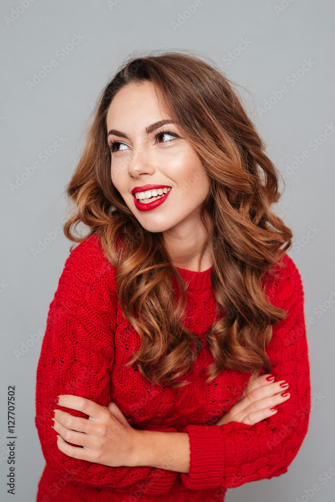 Smiling woman in red sweater looking to the right