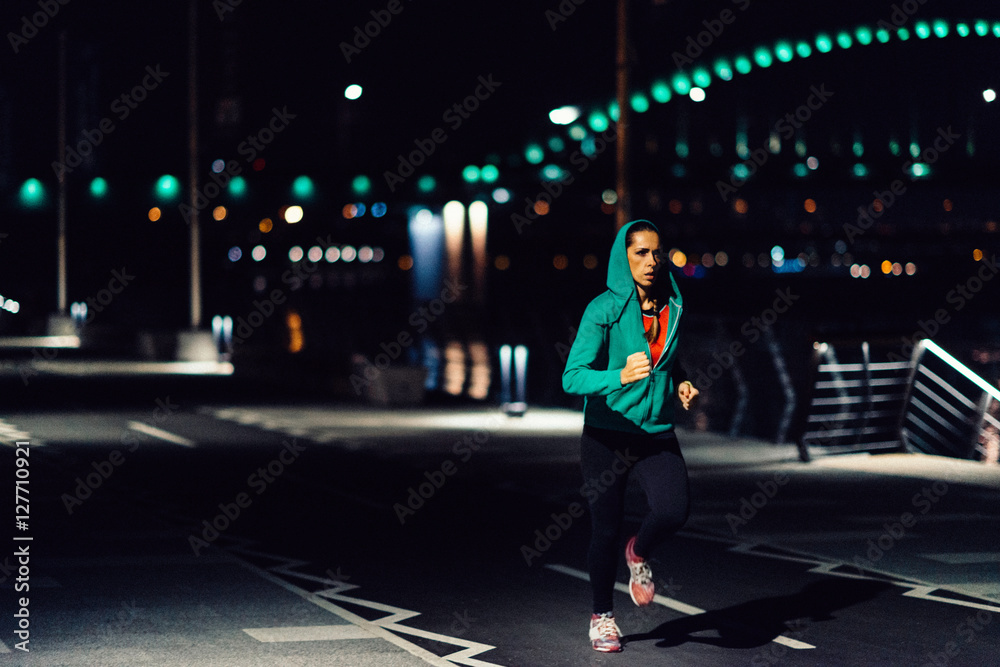 Jogging at night. Woman jogging at night Photos Adobe Stock