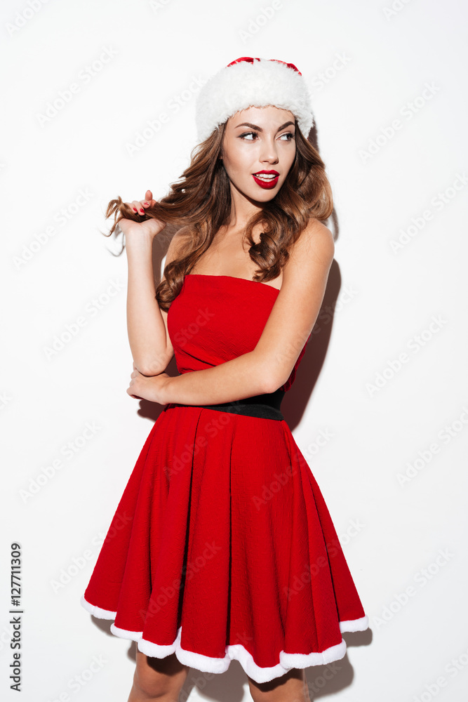 Pretty young brunette woman in red dress and hat posing Pretty young brunette woman in red dress and hat posing