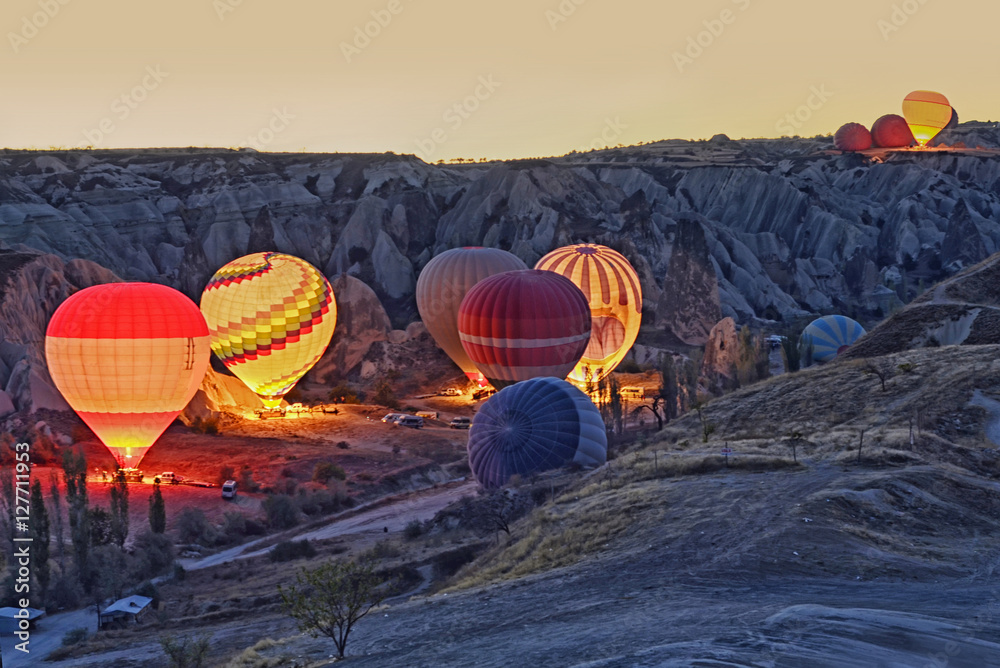 Obraz premium Colorful hot air balloons before launch at Cappadocia, Turkey. Volcanic mountains in Goreme national park