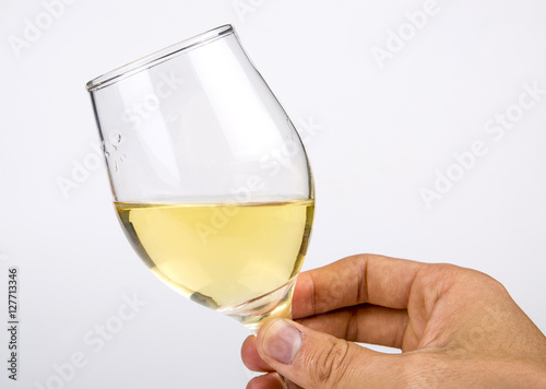 Holding hands a glass of white wine closeup