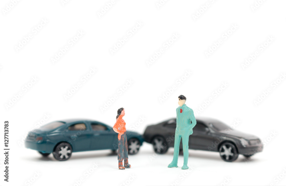 Miniature figures of people and car accident on white background Miniature figures of people and car accident on white background