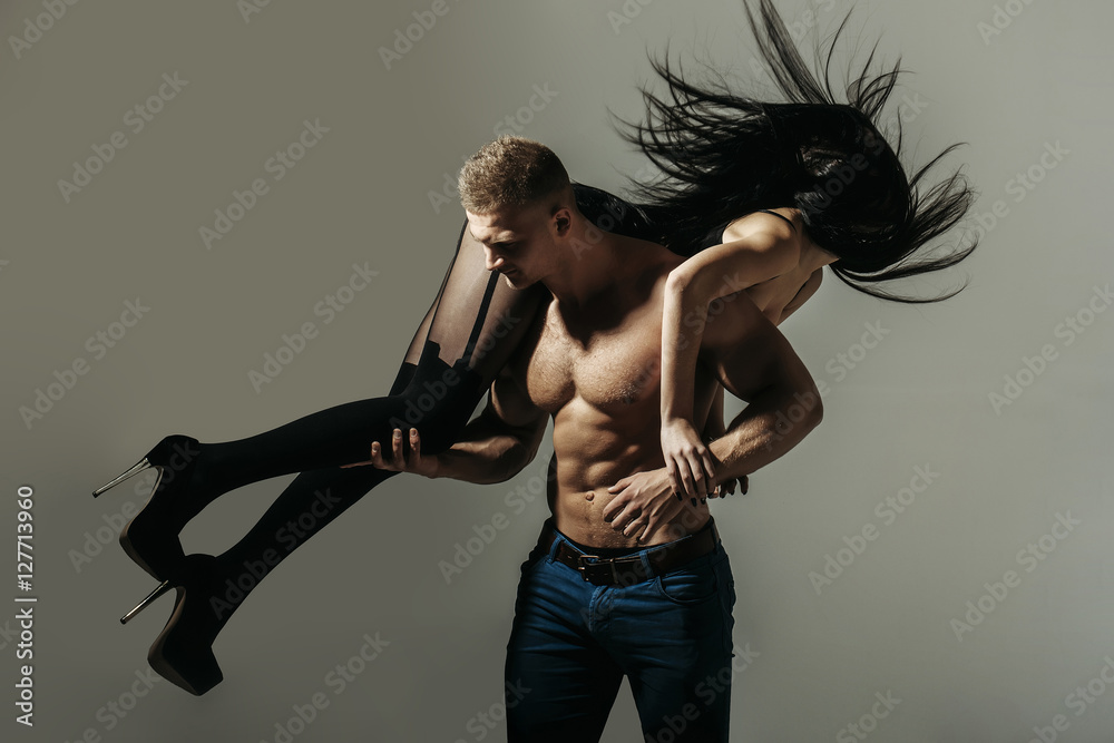 Naklejka premium muscular man and sexy girl