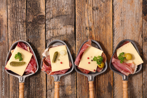 Photography raclette cheese and meats