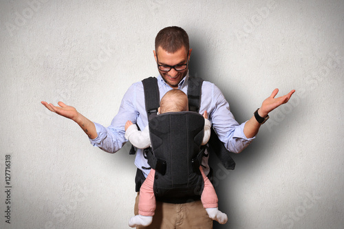 Fotografie Father holds a baby in a bag
