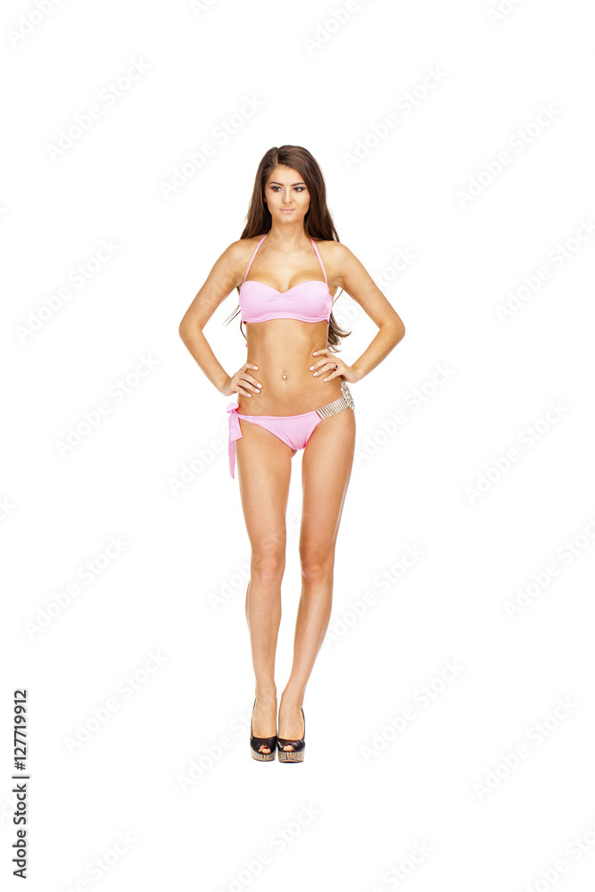 Fototapeta premium Snap model. Full length portrait of young woman wearing pink bik