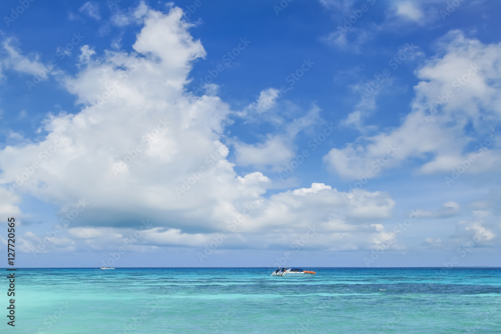 Tourist boat in the sea with cloudy blue sky Tourist boat in the sea with cloudy blue sky