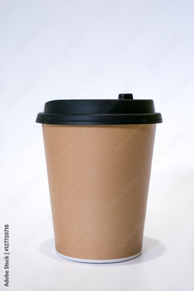 The brown paper cup of hot coffee with black cap. The brown paper cup of hot coffee with black cap.