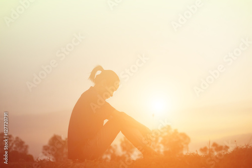 Sad and depressed woman sitting alone