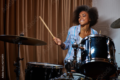 Black woman drummer in a recording studio