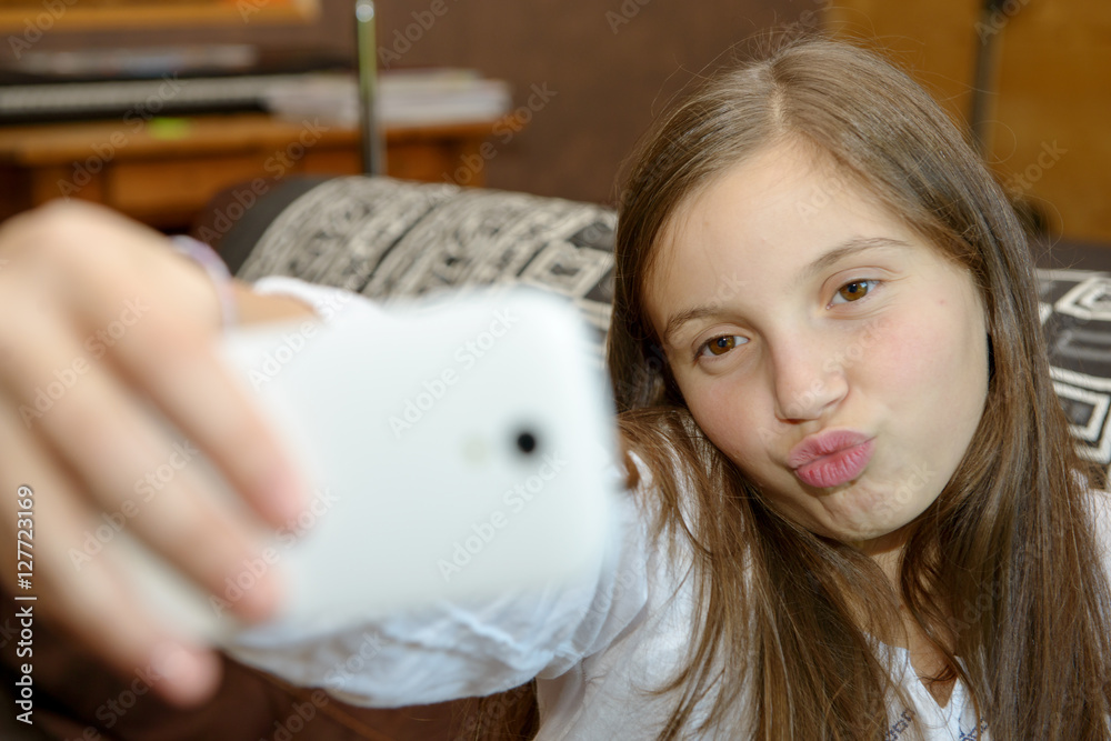 young teenage girl on home sofa couch taking selfie young teenage girl on home sofa couch taking selfie