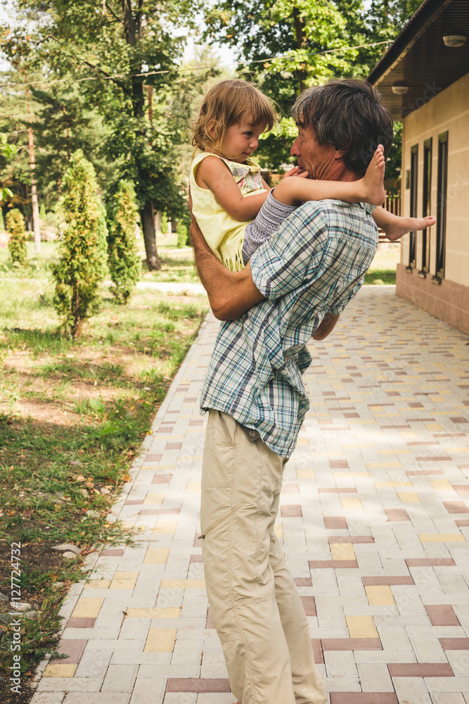 Fototapeta premium The family father and daughter outdoors.