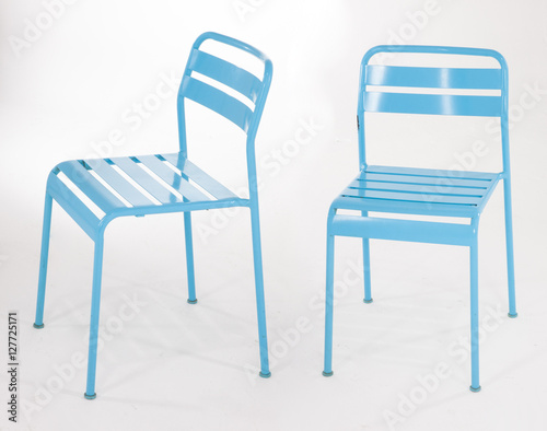 Turquoise metal chairs on white