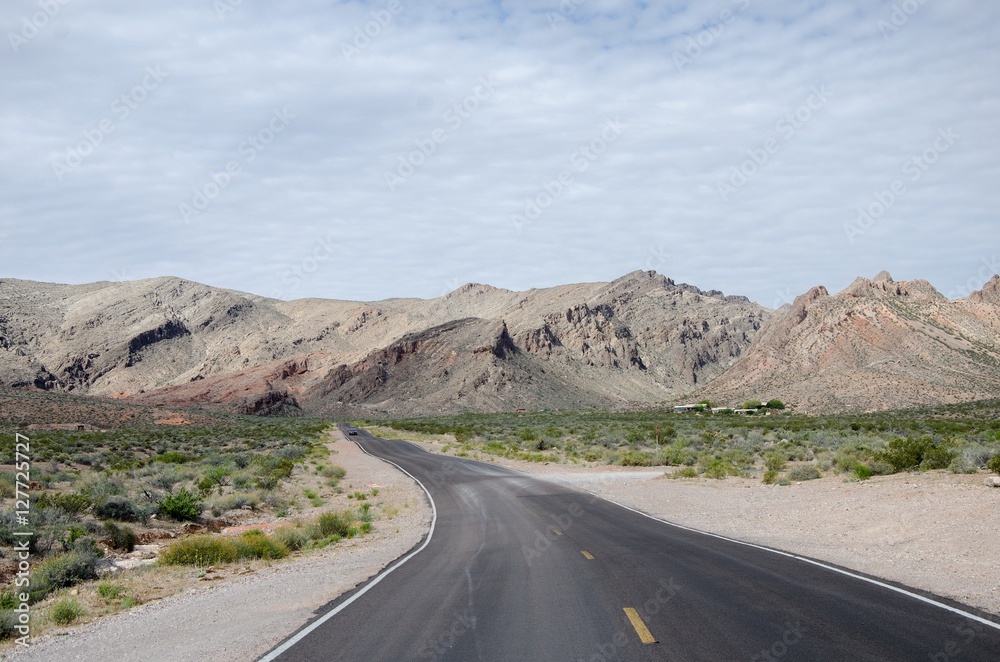 Road going towards arid mountains