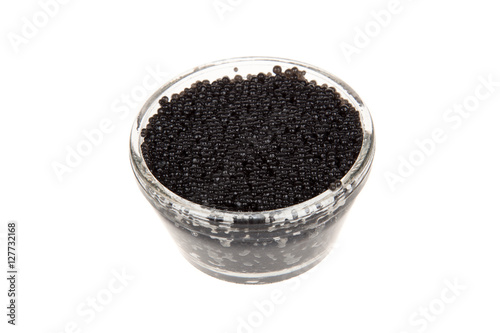 Black caviar in glass jar, isolated on white