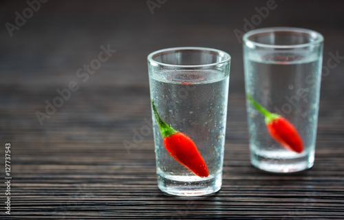 Two shot glasses with vodka, selectiv focus