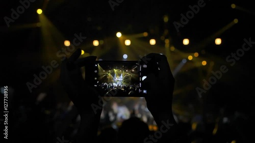 Fans waving their hands and hold the phone with digital displays