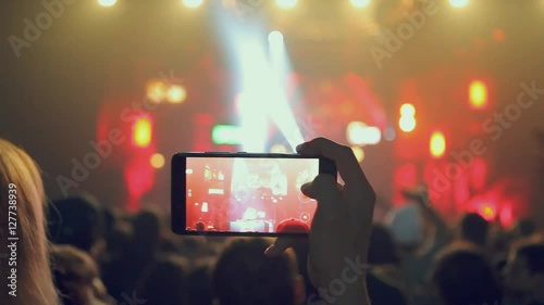 Fans waving their hands and hold the phone with digital displays