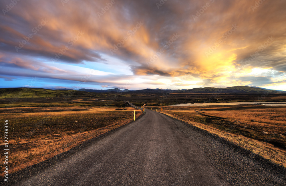 Asphalt road across the desert in Iceland, Sunset HDR
