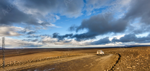 Traveling down the gravel road in desert, Kjolur Highland route F35 Volcanic Iceland photo