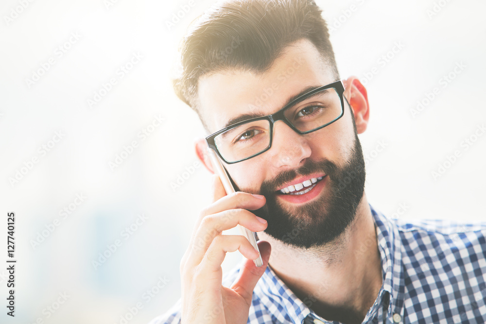 Smiling guy talking on phone