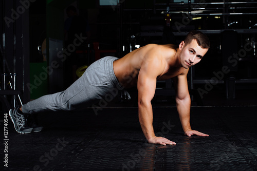 Men with battle rope in functional training fitness gym