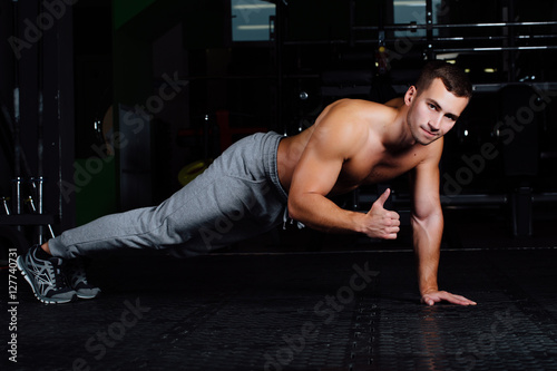 man doing push-up at gym .