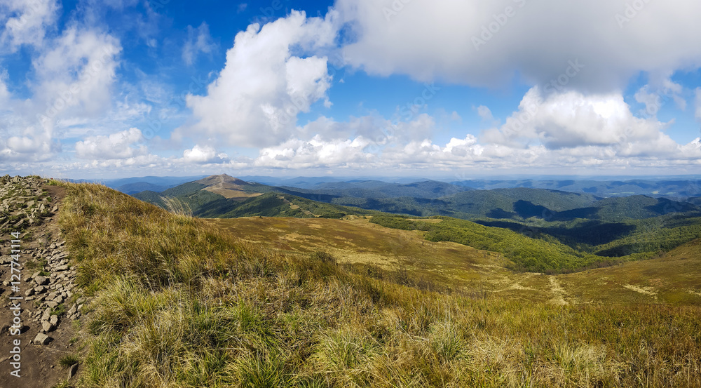 Mountains autumn scenery. Panorama of grassland and forest in Bieszczady National Park. Carpathians landscape, Poland.