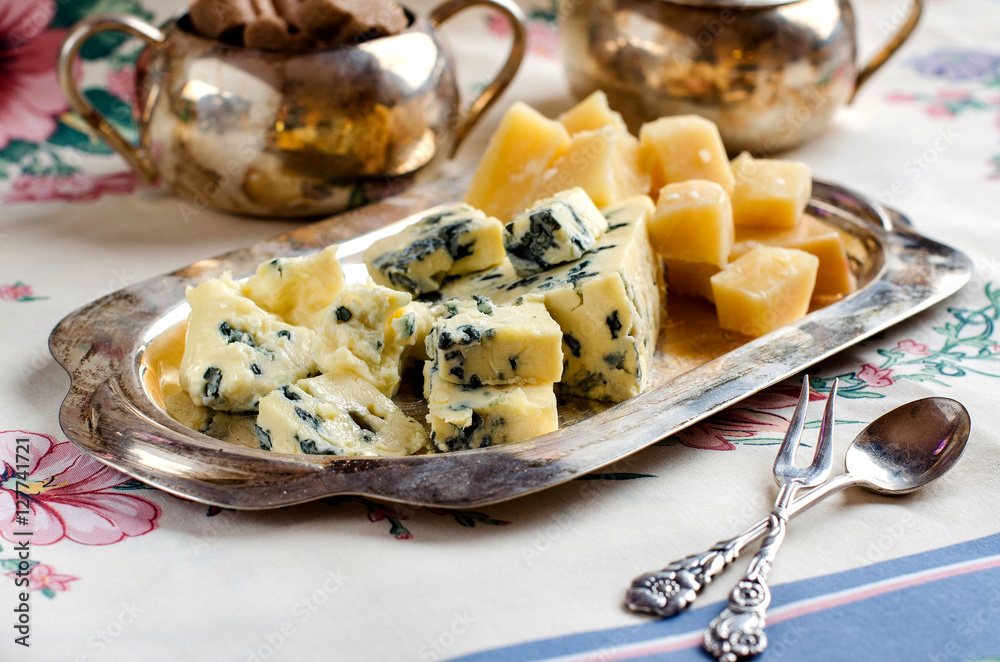 Assorted cheeses on a silver platter