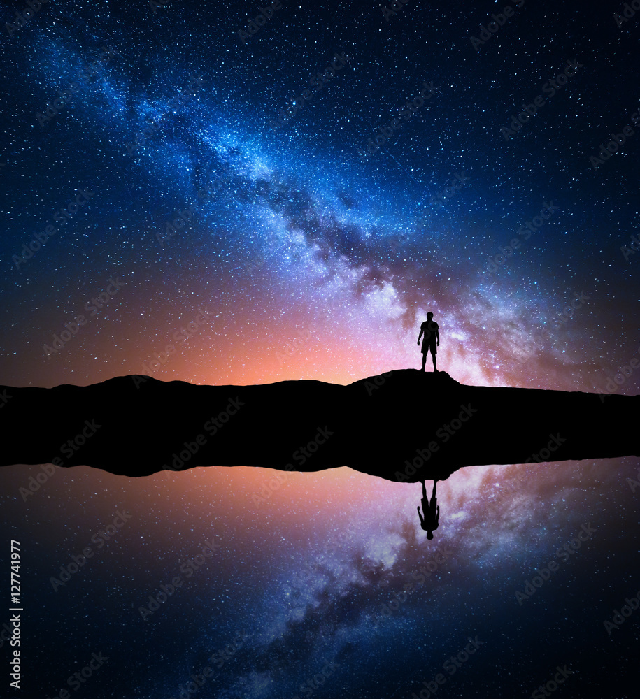 Milky Way. Night sky with stars and silhouette of a standing alone man ...